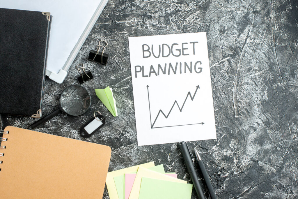 topviewbudgetplanningnotewithpensgraysurfacejobcopybookschoolstudentbusinessworkcollegemoneybudget Connect IT